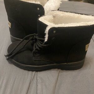This is a pair of black suede EO3 women's fur-lined ankle boots